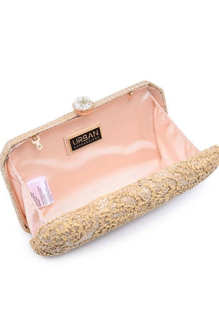 Clutch bag with gold textured exterior and pink interior on a white background