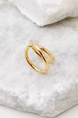 Gold ring on a textured white stone surface