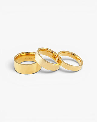 Three gold rings stacked on a white background