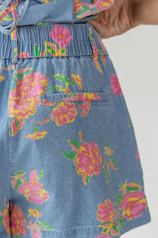 Close up of women's Jardin floral denim shorts showing delicate floral print, elastic waistband detail and lightweight 100% cotton fabrication