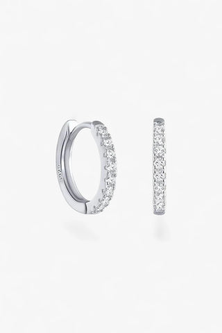 Women's silver pavé huggie hoop earrings with cubic zirconia stones and polished finish