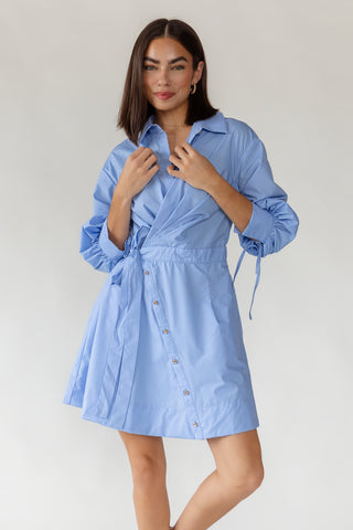 Front detail of women's Portofino sky blue wrap mini dress showing notched collar, button-front closure and self-tie wrap waist
