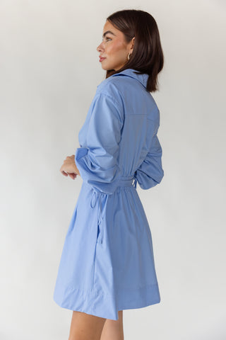 Side view of women's Portofino sky blue long sleeve wrap mini dress showing relaxed fit and lightweight woven fabrication
