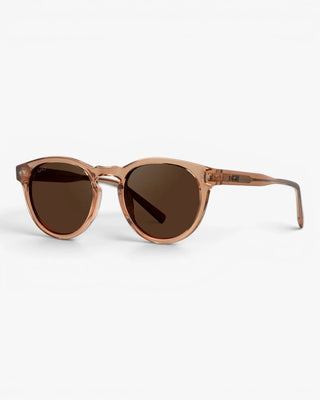 Sunglasses with green lenses and a light pink frame on a white background