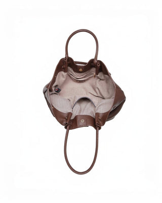 Brown leather handbag with beige interior on a white background