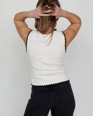 JO+CO cream knit vest with black scalloped trim and gold buttons, V-neck, sleeveless, fitted silhouette.