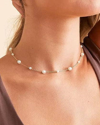 JO+CO mini pearl choker necklace with delicate gold chain and acrylic pearls, adjustable length.